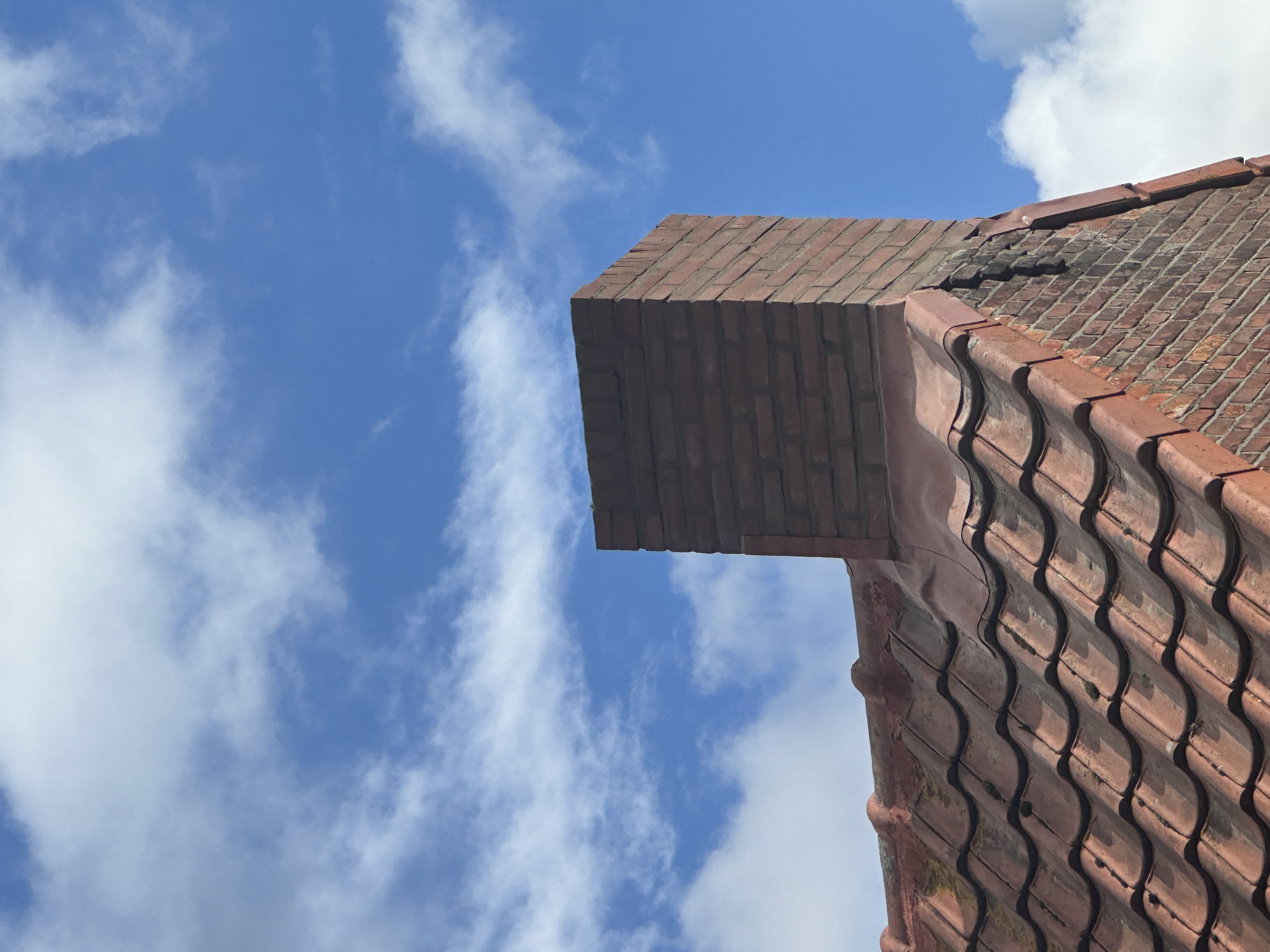 Gemetselde schoorsteen tegen een blauwe lucht, eigen werk